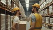 © Pojjanee - Warehouse Workers Collaboration: Two warehouse workers in yellow hard hats and vests, engaged in conversation amidst towering warehouse shelves.