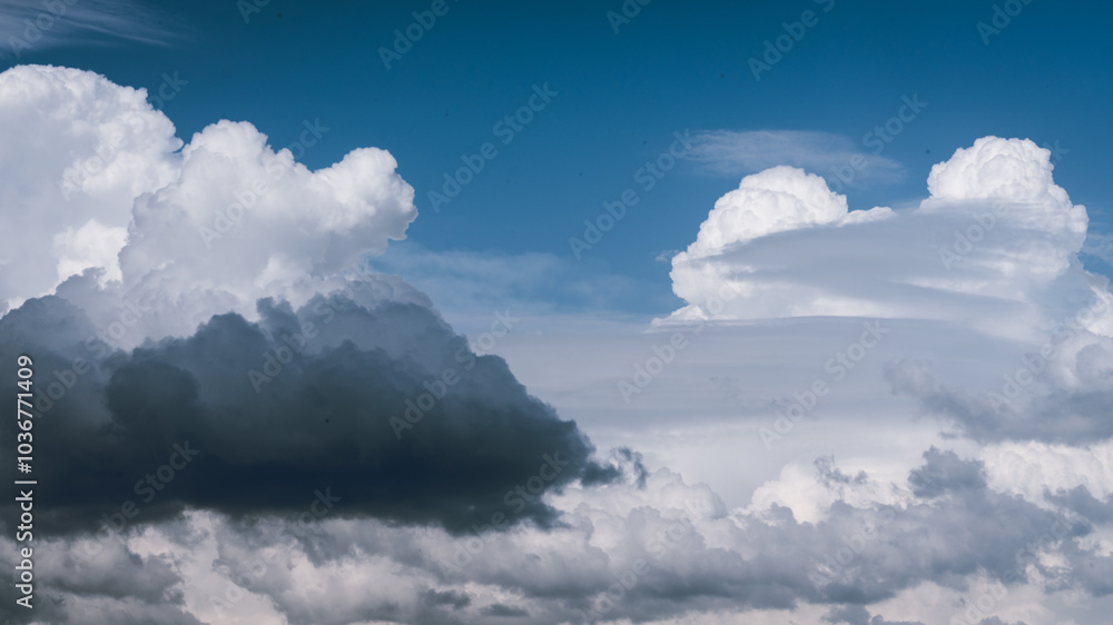 Clouds of different shapes and colors on a blue sky background. A ...