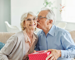 Wall Mural - gift woman man couple happy love happiness present kiss romantic smiling together box wife husband e