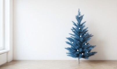 A blue Christmas tree stands in a white room with a window