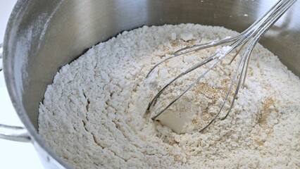 Yeast and flour mix with a whip