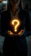 © Thares2020 - Businesswoman Holding Glowing Question Mark Representing Power of Inquiry and Problem Solving in Business