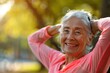 © LukaszDesign - Senior woman smiling while stretching outdoors for health and wellness. Mature lady engaging in exercise for relaxation, energy, and fitness