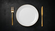 © AngrySun - Minimalist served white plate with golden fork and knife, copy space, black background. Generative AI