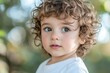 © Vii - A young child with curly hair and bright blue eyes, suitable for various uses including family, portrait, and childhood themes