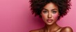 © Wall - A women with wavy hair tossing in the wind, revealingly showcasing her pink makeup look