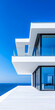 © JuanM - Modern seaside villa with expansive views and sleek lines under a clear blue sky