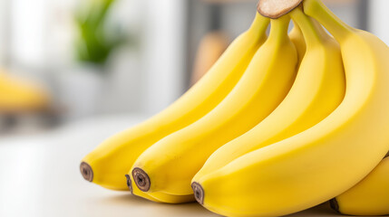 Fresh bunch of bananas on a white countertop with a shallow depth of field in a close-up shot