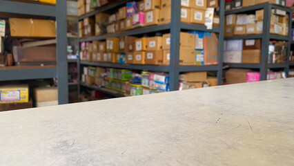 A view of a storage room with shelves filled with boxes. The organized arrangement highlights a workspace dedicated to inventory management and storage solutions..