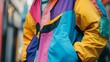 © Tonadech - A detailed close-up of a 90s-style windbreaker with exaggerated colors and textures against a bright urban background