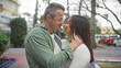 © Krakenimages.com - A loving couple embraces on a city street, conveying affection and togetherness in an urban outdoor setting.