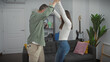 © Krakenimages.com - A man and woman dance joyfully in their modern apartment living room, exuding love and togetherness.