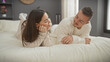 © Krakenimages.com - A loving couple enjoys a relaxed moment together in the comfort of their modern bedroom interior.