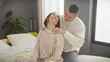 © Krakenimages.com - A loving couple enjoys a peaceful moment together in a cozy bedroom setting, expressing affection and comfort