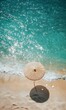 © jambulart - Beach umbrella, sandy shore, turquoise water, shells.