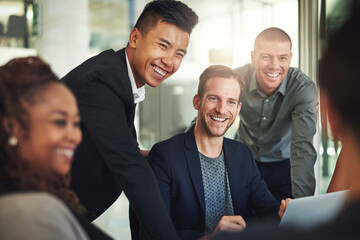 Canvas Print - Team, smile and man in interview with laptop, meeting and funny support on project management. Leadership, solidarity and group of happy business people in office with mentor, advice or strategy plan