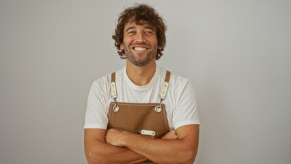 Young man smiling confidently with arms crossed wearing casual attire isolated over white background