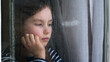 © Yuliia - Caucasian little girl looking out window rainy weather dropping sadness anxiety stress crisis divorce unhappy child offspring kid psychological trauma descendant despondency schoolgirl pupil lonely