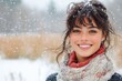 © petro - Beautiful young woman smiling while snowing outside