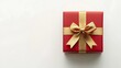 © WINGGOD - Red gift box with a gold ribbon tied in a bow, isolated on a white background