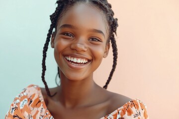 Joyful young woman smiling with braided hair against a colorful background