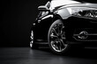 © Asim-Backgrounds - sleek and stylish black car with chrome wheels on a dark background