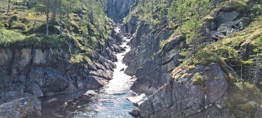 Wall Mural - fresh mountain water stream running through a steep v shaped valley in norway