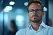 © Odin AI - A focused businessman with glasses adopts a contemplative stance in a sleek office setting, conveying a sense of strategy, critical thinking, and preparedness.