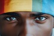 © Odin AI - A close-up of captivating eyes under a colorful headband, showcasing intense expression and boldly highlighting diversity, emotion, and a vibrant spectrum of colors.