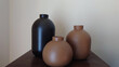 © Richard Marx - three ceramic or clay vases against a white wall