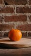 © GS-Studio - Single Mandarin Orange on Wooden Cutting Board with Brick Background