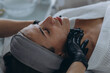 © Екатерина Лукашина - Cosmetologist performs a facial peeling procedure on a young woman.
