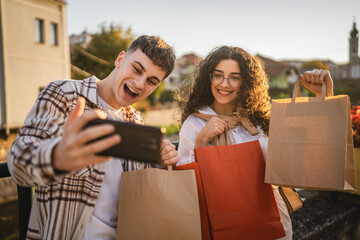 Boyfriend take a self portrait with his girlfriend hold shopping bags