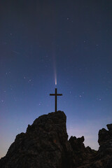Wall Mural - Silhouettes of crucifix symbol on top mountain with Comet tail in the sky night landscape background