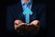 © JK_kyoto - Businessman holding digital arrow symbolizing growth and success on a dark background.
