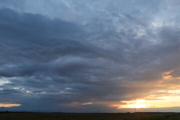 Wall Mural - picturesque view of sky with clouds on sunset