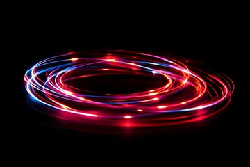 Wall Mural - Abstract light trails in red and blue create a mesmerizing circular pattern against a black background.