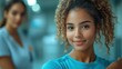 © artzone - Two young women in a bright, modern space, one smiling confidently.