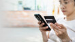 © Ton Photographer4289 - Woman hand holding credit card and smartphone for paying online using banking service. Online shopping concept