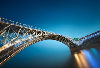 Sticker - A metal arch bridge spans a body of water, with a deep blue sky and soft, blurred reflections in the water.