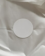 © Nicole Wu - A circular textured paper white label on tissue packaging paper mockup