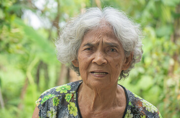 Elderly Asian woman looking up