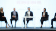 © N7 - Panel Discussion Blur: A blurred background of a panel discussion in a conference hall, with panelists and a moderator.
