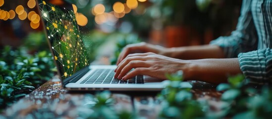 Sticker - Person's hands typing on a laptop with a green and yellow pattern on the screen surrounded by lush green plants.