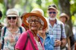 © Iigo - Portrait of a happy senior woman walking in the park with her family