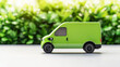 © Piya W. - A vibrant green toy van is showcased against a backdrop of lush greenery, emphasizing a theme of transportation and eco-friendliness.