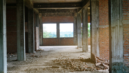 Abandoned building interior with exposed brick walls and debris