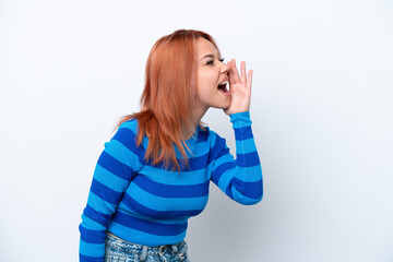 Young Russian girl isolated on white background shouting with mouth wide open to the side