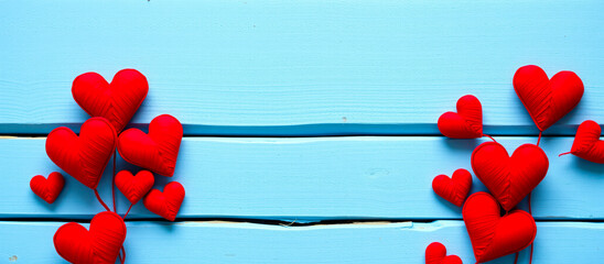 Poster - red fabric hearts decorated on light blue wood