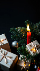 Canvas Print - red candle burns brightly amidst presents evergreen branches